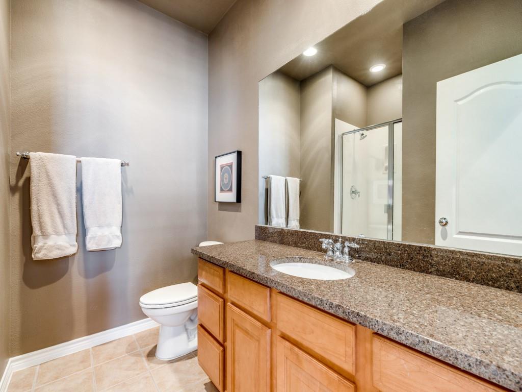 15741 Seabolt Place, Unit 28 Addison, TX 75001 - Photo 23 of 40 a bathroom with a granite countertop sink a toilet and a mirror