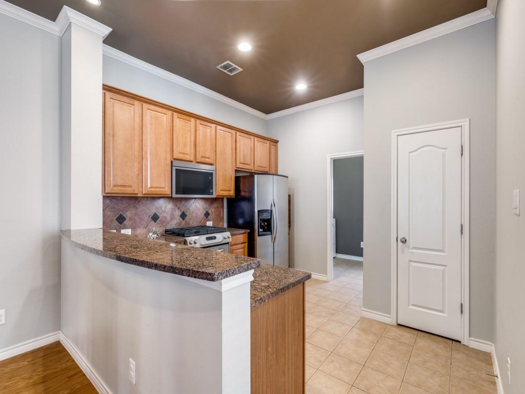 15741 Seabolt Place, Unit 28 Addison, TX 75001 - Photo 10 of 40 a kitchen with stainless steel appliances granite countertop a refrigerator stove and sink