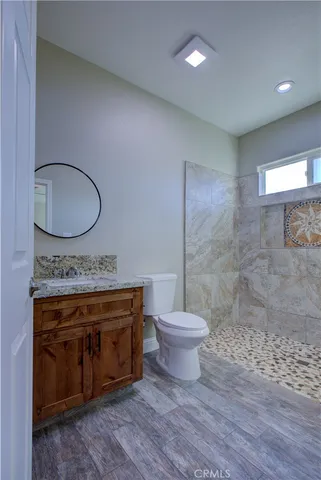 a view of bathroom with a toilet a sink and a mirror