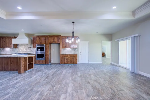a view of a kitchen with a sink and a refrigerator