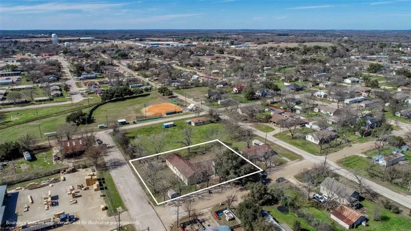 an aerial view of a houses with a yard