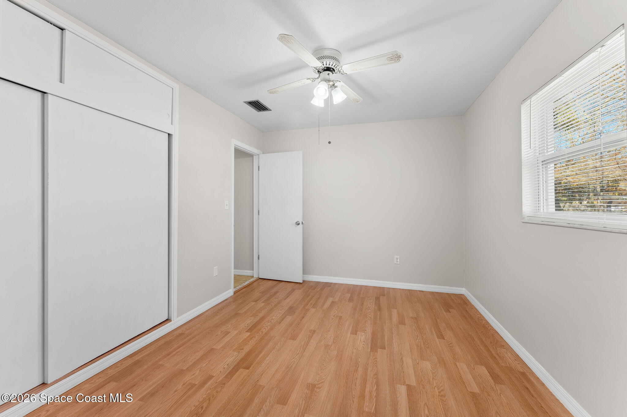 1045 Collins Street Melbourne, FL 32935 - Photo 11 of 27 wooden floor in an empty room with a window