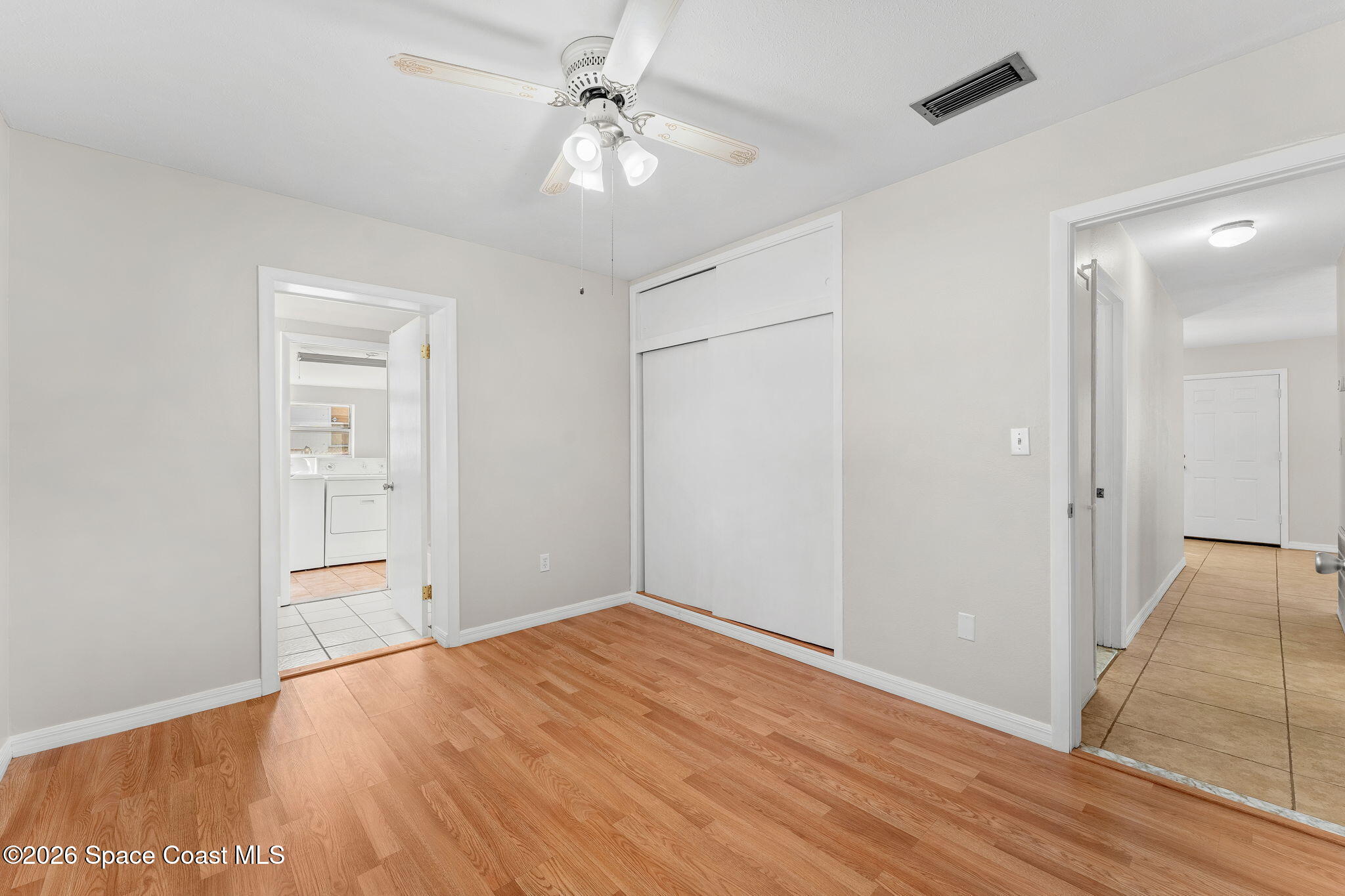 1045 Collins Street Melbourne, FL 32935 - Photo 12 of 27 wooden floor in an empty room with a window