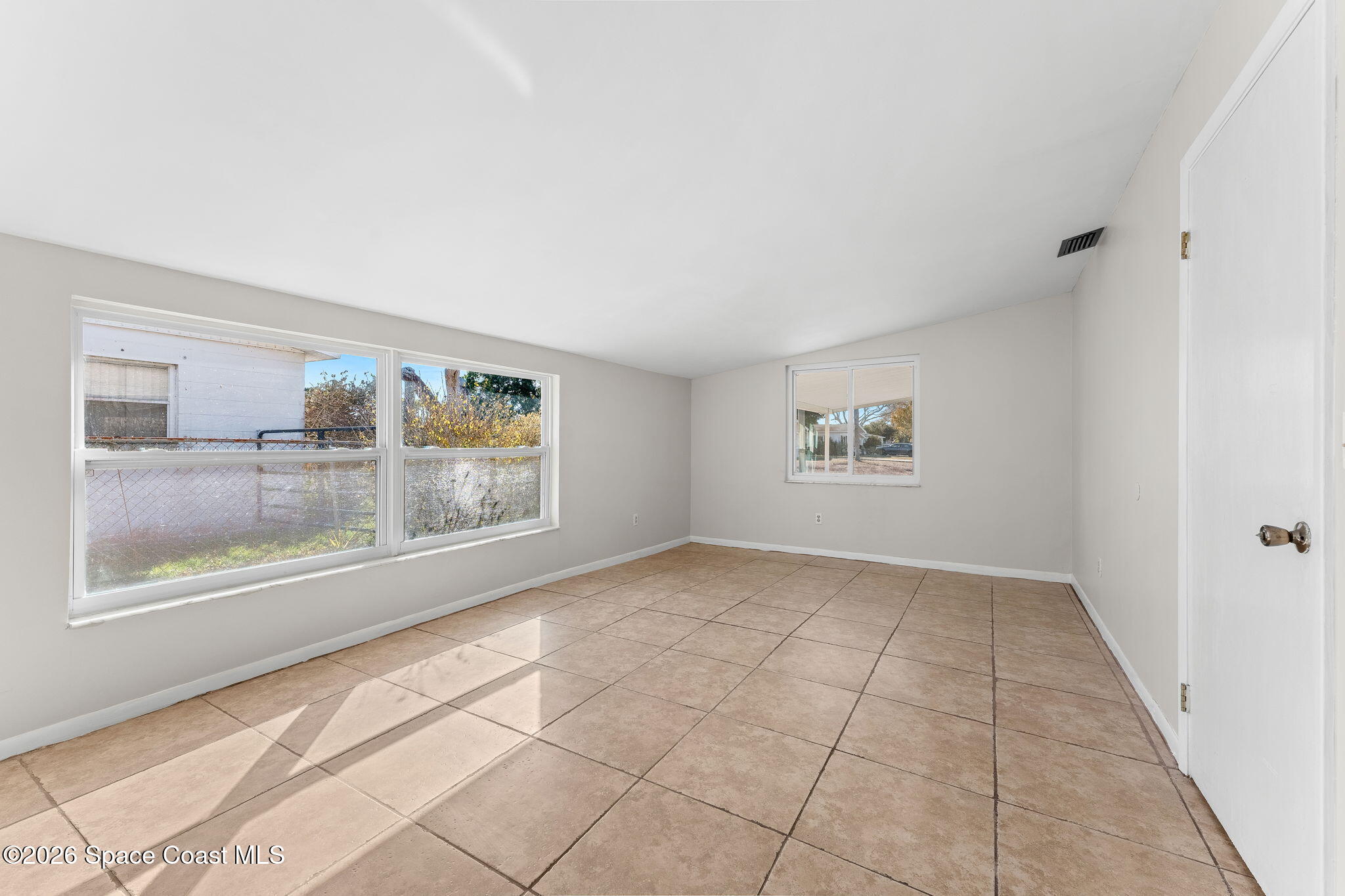 1045 Collins Street Melbourne, FL 32935 - Photo 15 of 27 an empty room with entrance and windows