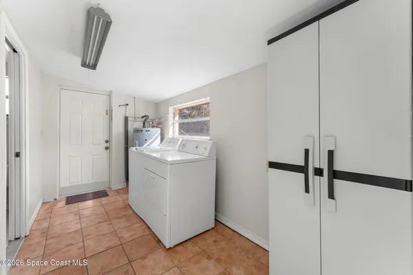 a hallway with a washer and dryer