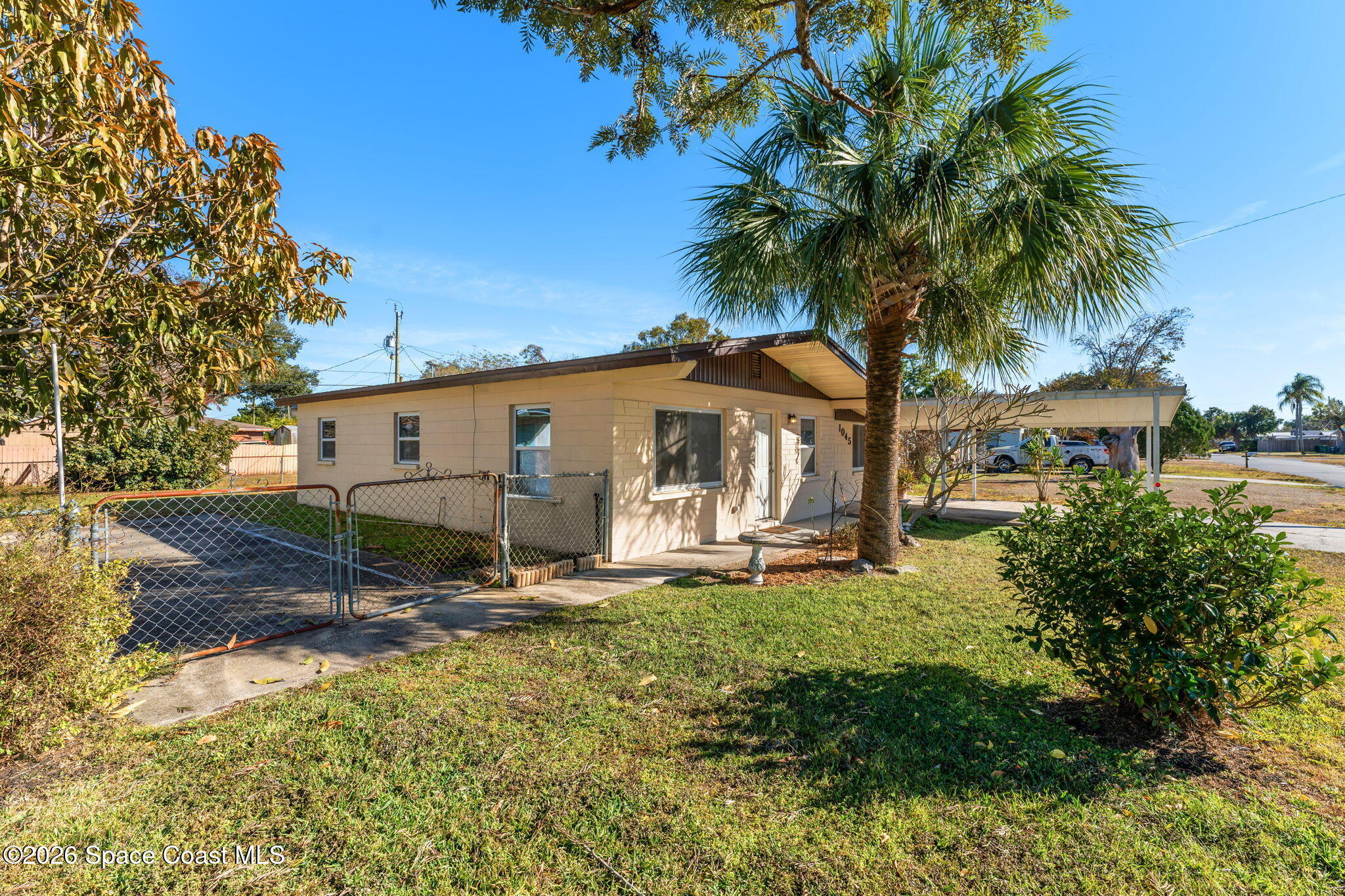 1045 Collins Street Melbourne, FL 32935 - Photo 20 of 27 front view of a house with a yard
