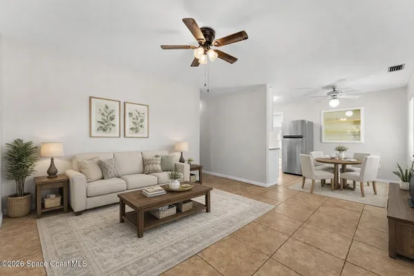 a living room with furniture and kitchen view