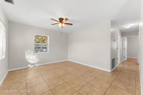 a view of an empty room and a window