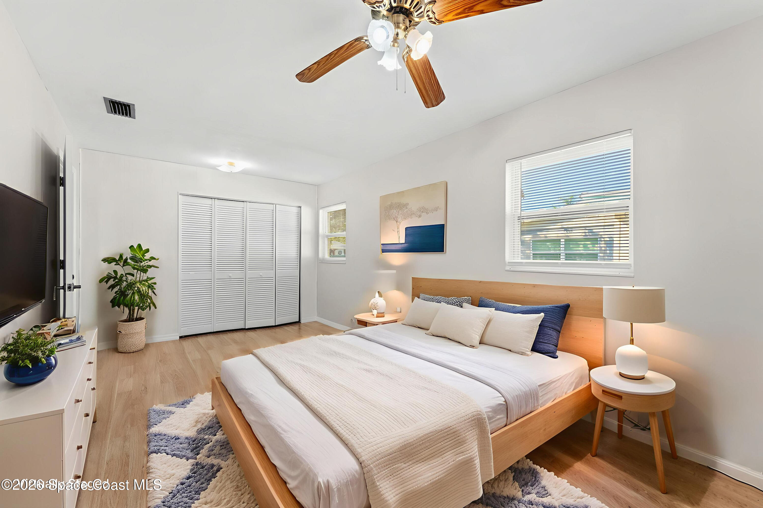 1045 Collins Street Melbourne, FL 32935 - Photo 7 of 27 a bedroom with a bed and a chandelier