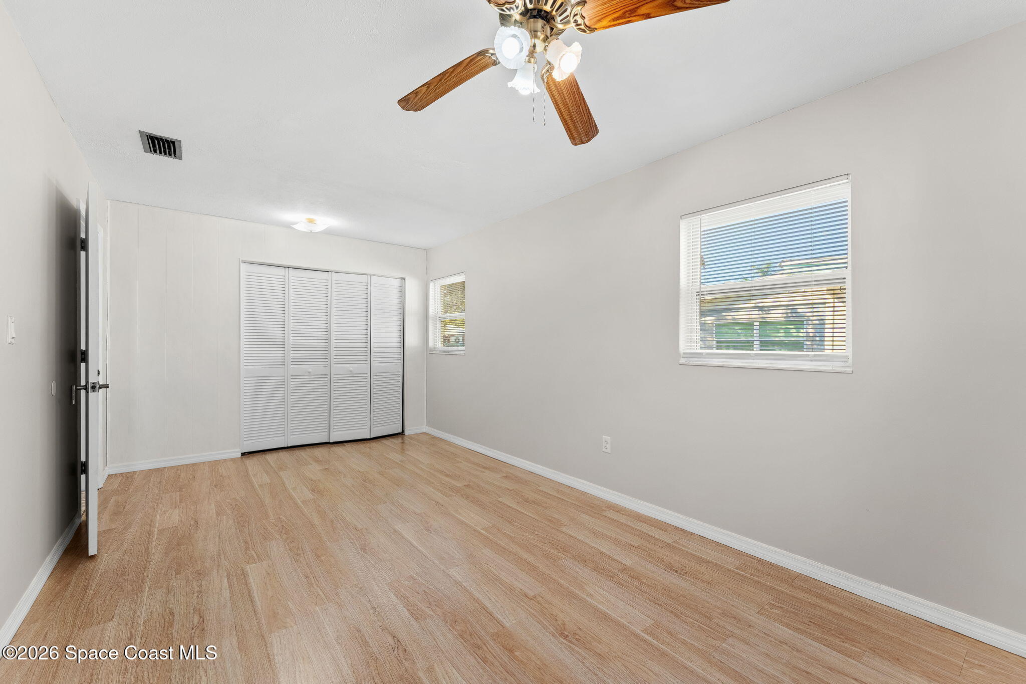 1045 Collins Street Melbourne, FL 32935 - Photo 8 of 27 wooden floor in an empty room with a window