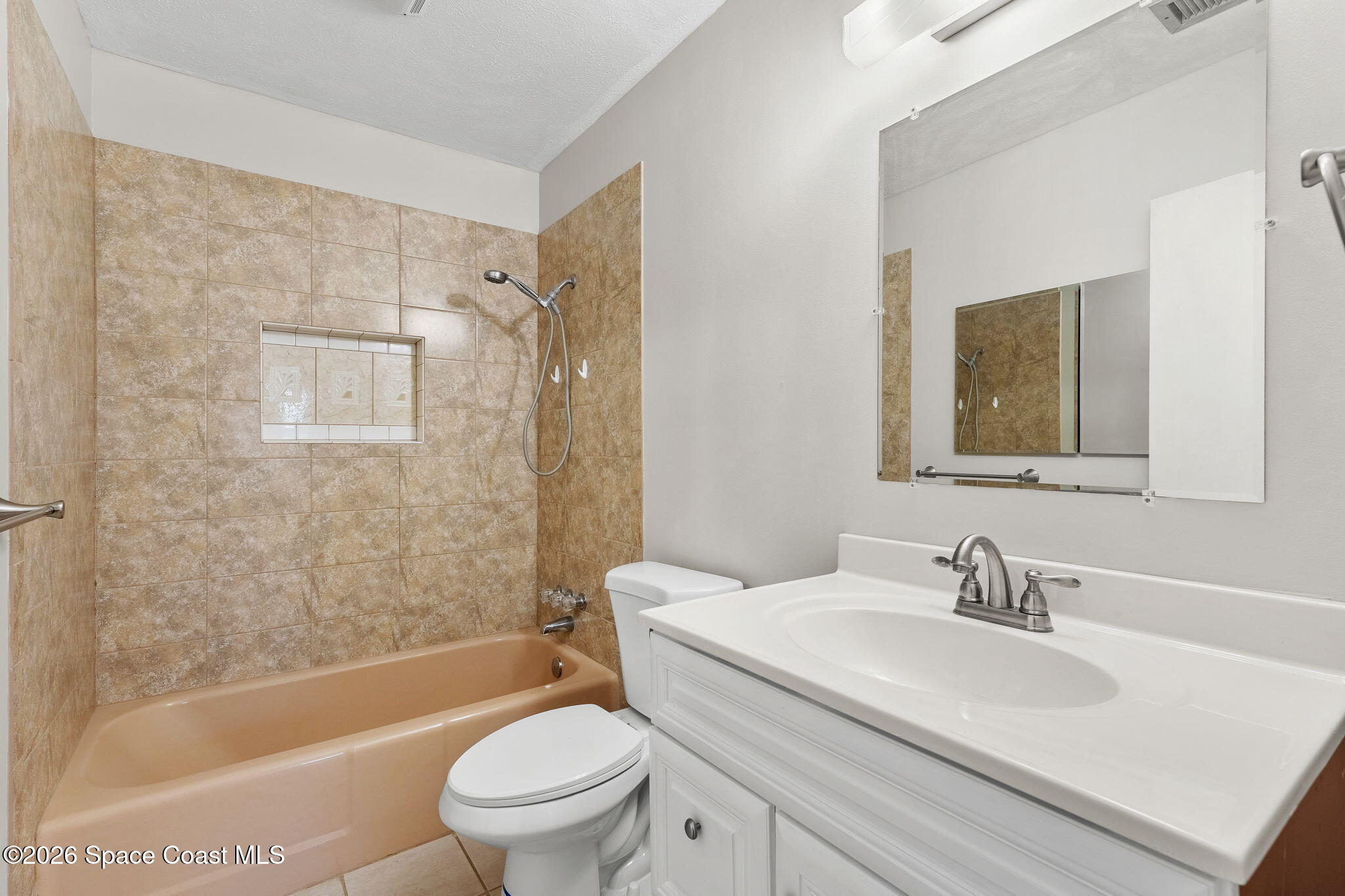 1045 Collins Street Melbourne, FL 32935 - Photo 9 of 27 a bathroom with a sink toilet and shower