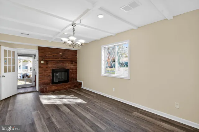 wooden floor in an empty room with a fireplace