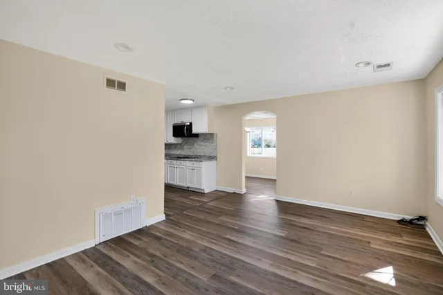 a view of a kitchen with wooden floor and a sink