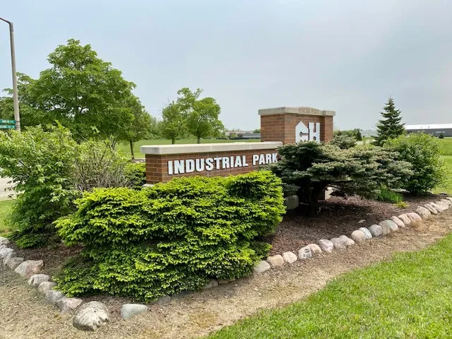 a view of a sign board with garden