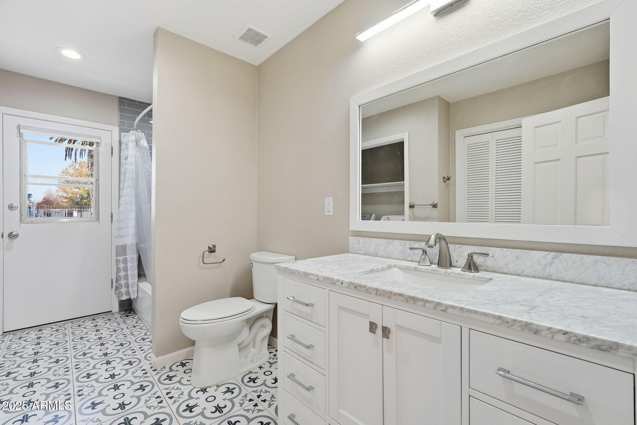 914 South 132nd Street Gilbert, AZ 85233 - Photo 30 of 55 a bathroom with a granite countertop toilet a sink a mirror and a shower