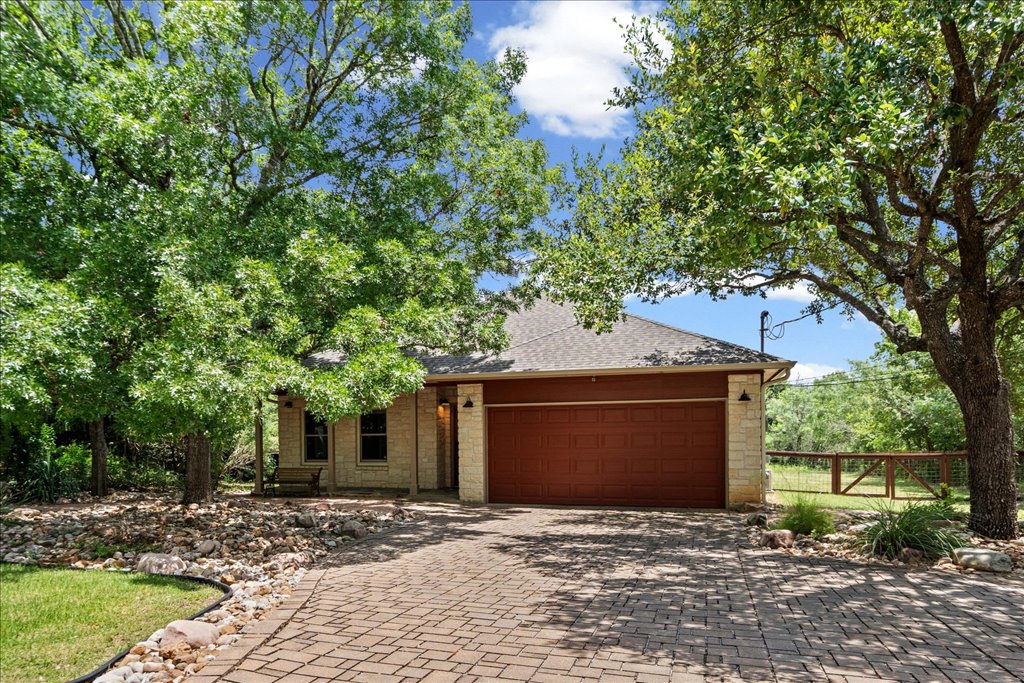 37 Pillow Road Austin, TX 78745 - Photo 2 of 18 Mature trees frame this charming residence with an attractive brick paver driveway and natural rock landscaping.