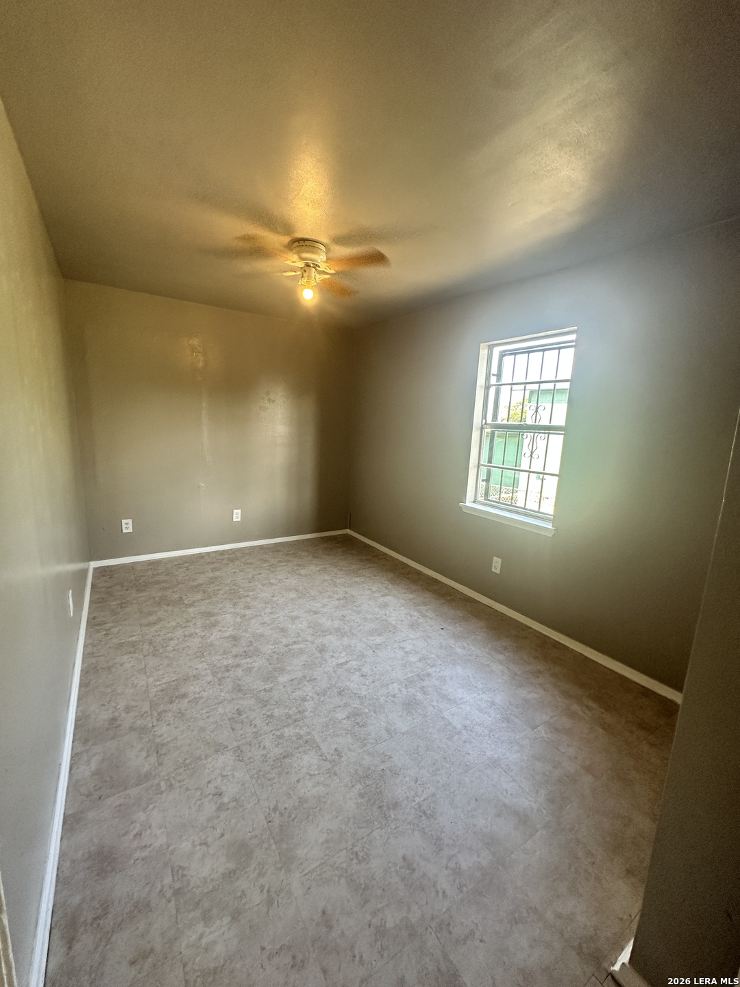 515 Clark Avenue San Antonio, TX 78210 - Photo 6 of 11 an empty room with windows and fan