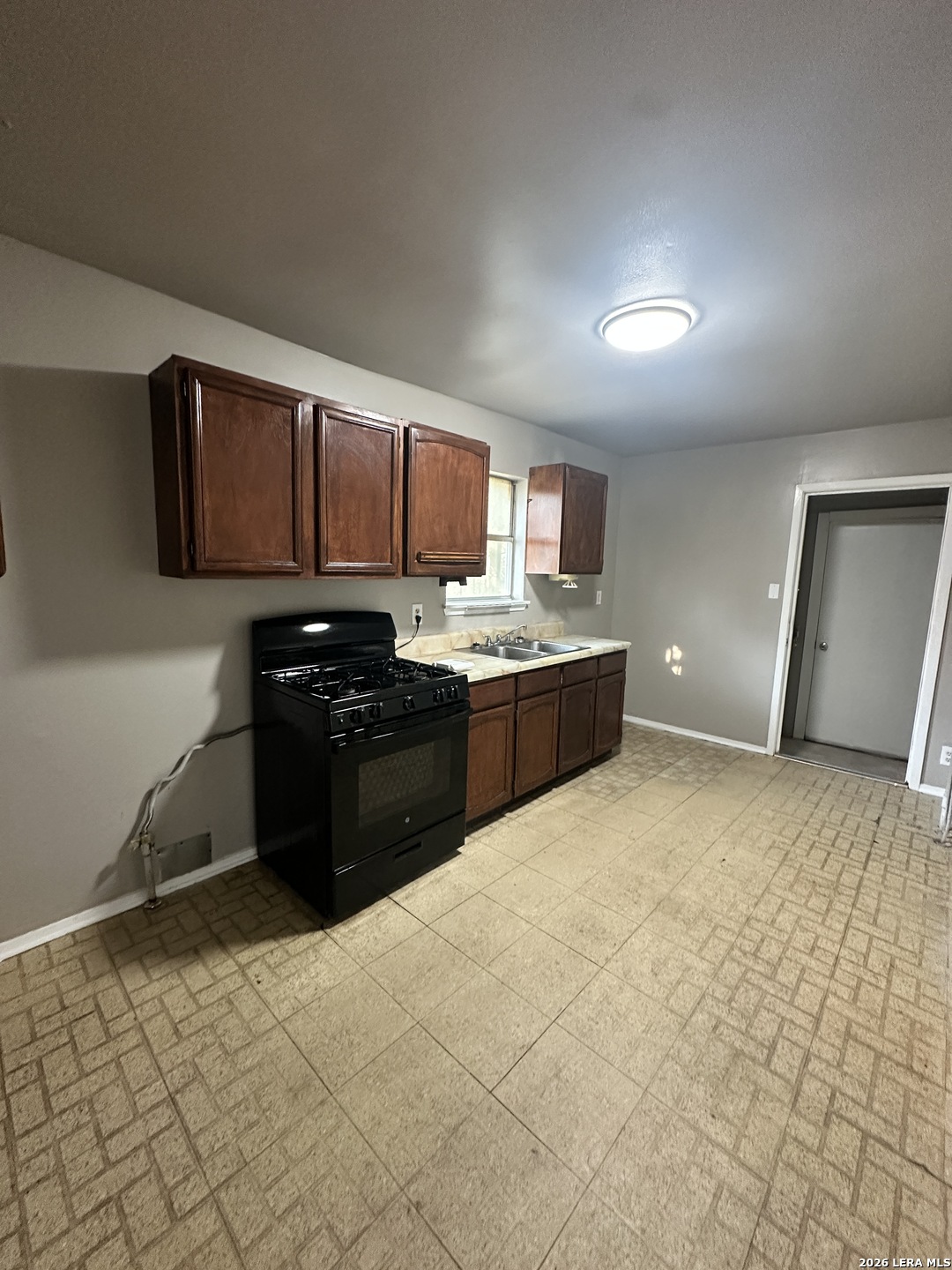 515 Clark Avenue San Antonio, TX 78210 - Photo 9 of 11 a large kitchen with stainless steel appliances granite countertop a stove a sink and a refrigerator