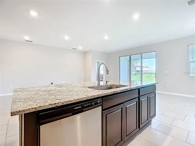 a kitchen with granite countertop stainless steel appliances and counter space