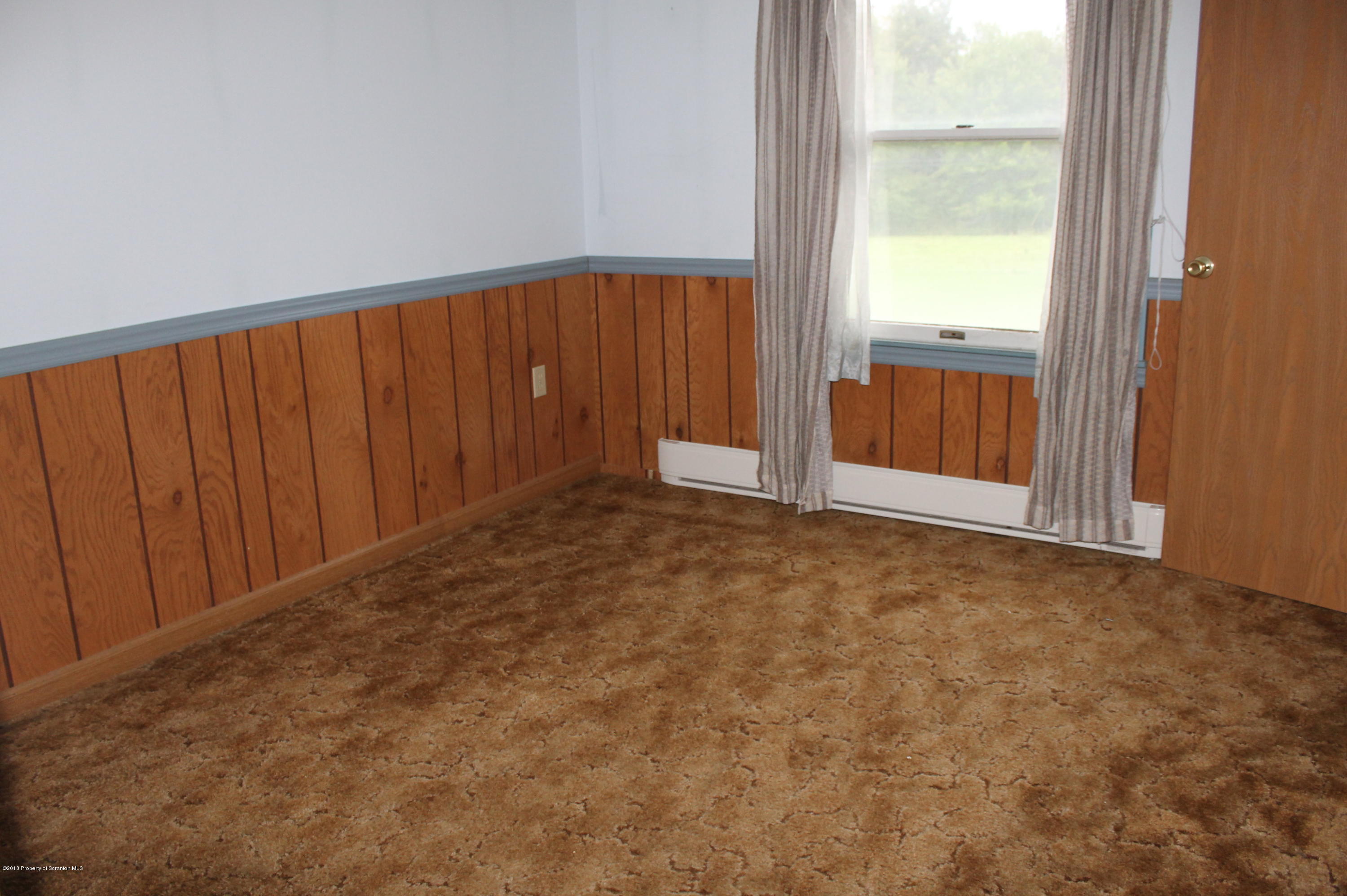 48 Seeley Road Lake Ariel, PA 18436 - Photo 8 of 23 an empty room with a wooden door