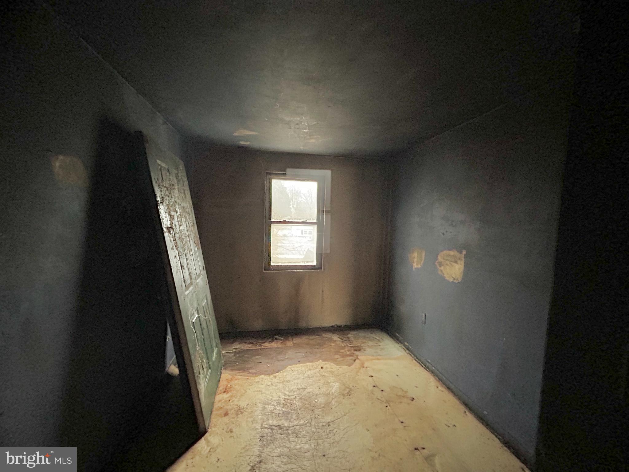 411 Clover Court Taneytown, MD 21787 - Photo 11 of 17 wooden floor in an empty room with a window