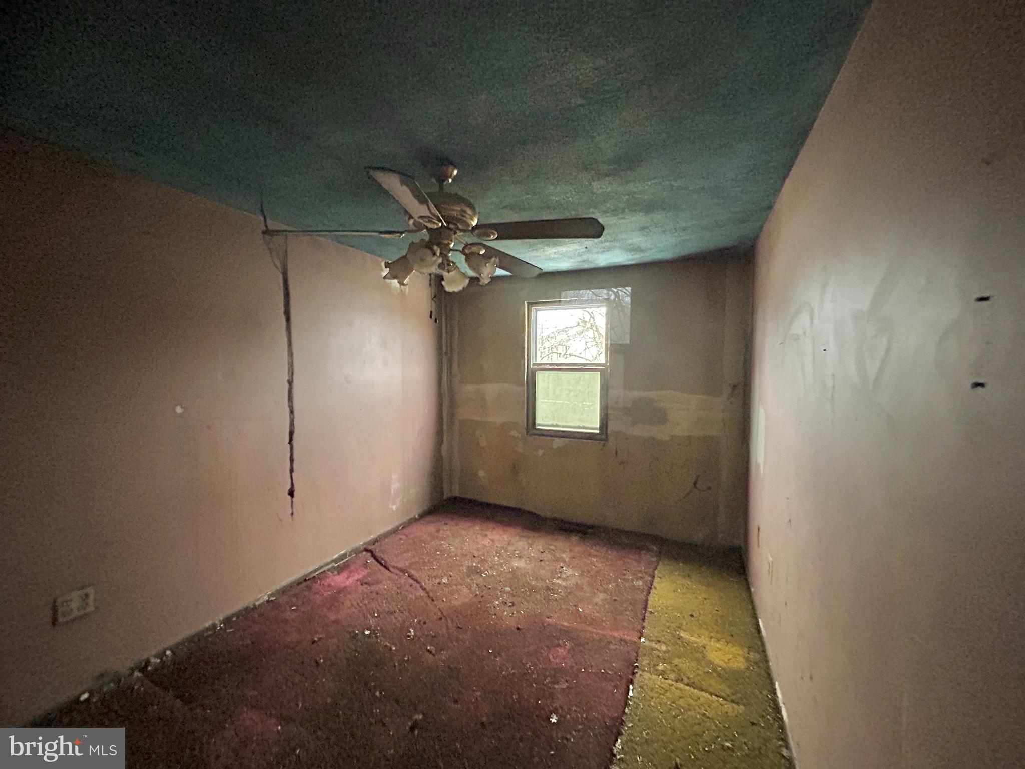 411 Clover Court Taneytown, MD 21787 - Photo 12 of 17 en empty room with windows and chandelier fan