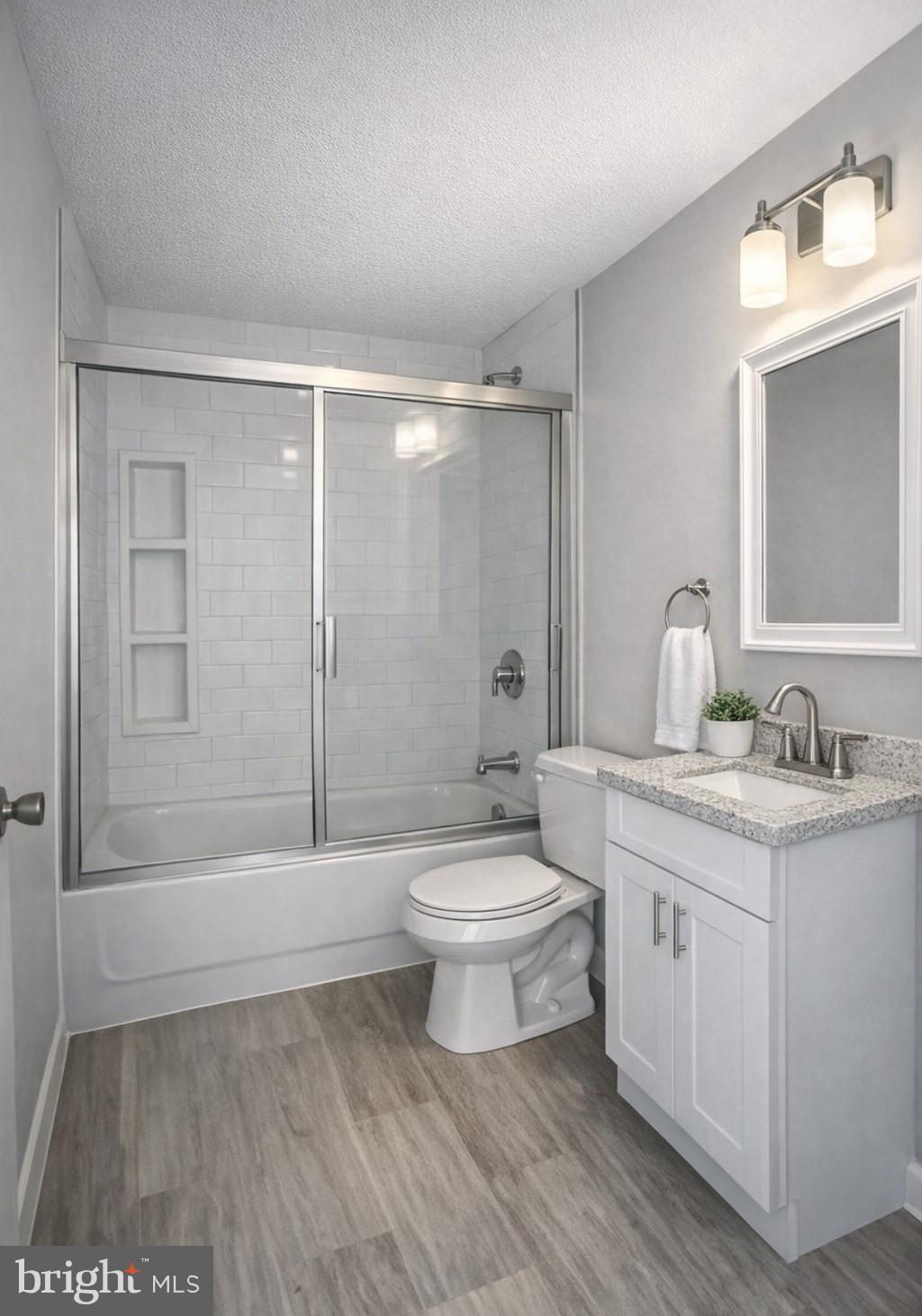 411 Clover Court Taneytown, MD 21787 - Photo 10 of 17 a bathroom with a toilet a sink a mirror a bathtub and vanity