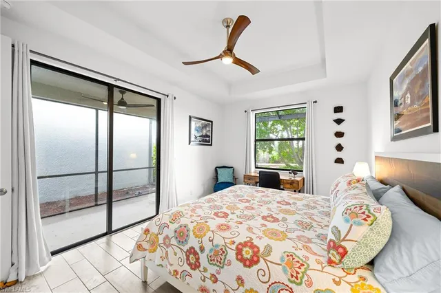 a bedroom with a bed and a dresser next to a window