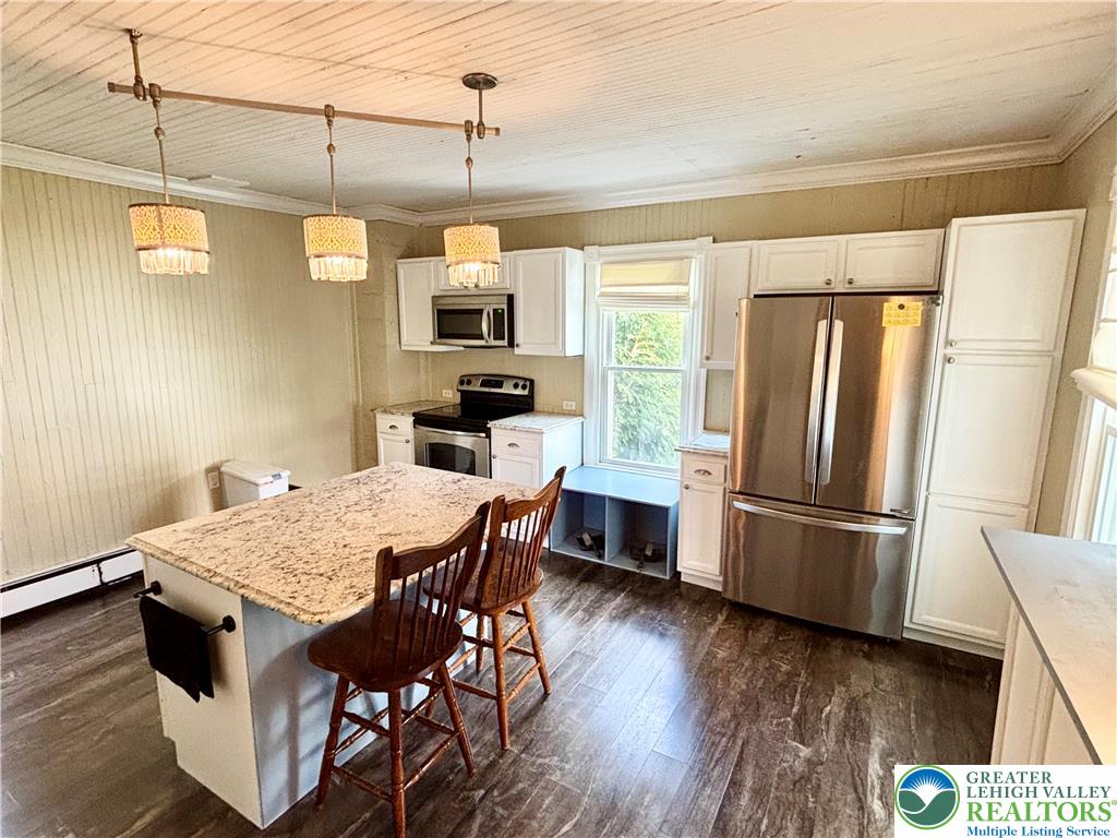 7241 Decatur Street New Tripoli, PA 18066 - Photo 3 of 36 Granite counters and stainless steel appliances complete this bright, inviting kitchen.