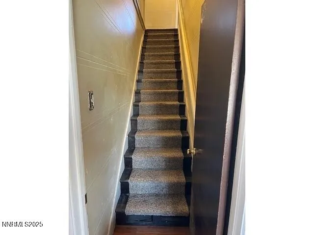 a view of staircase with wooden floor
