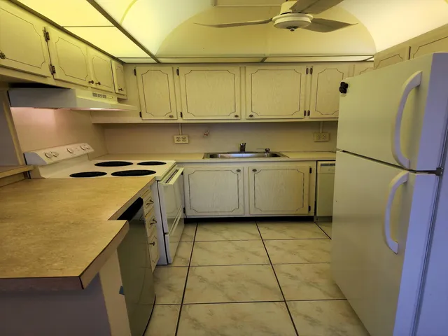 a kitchen with stainless steel appliances granite countertop refrigerator sink and cabinets