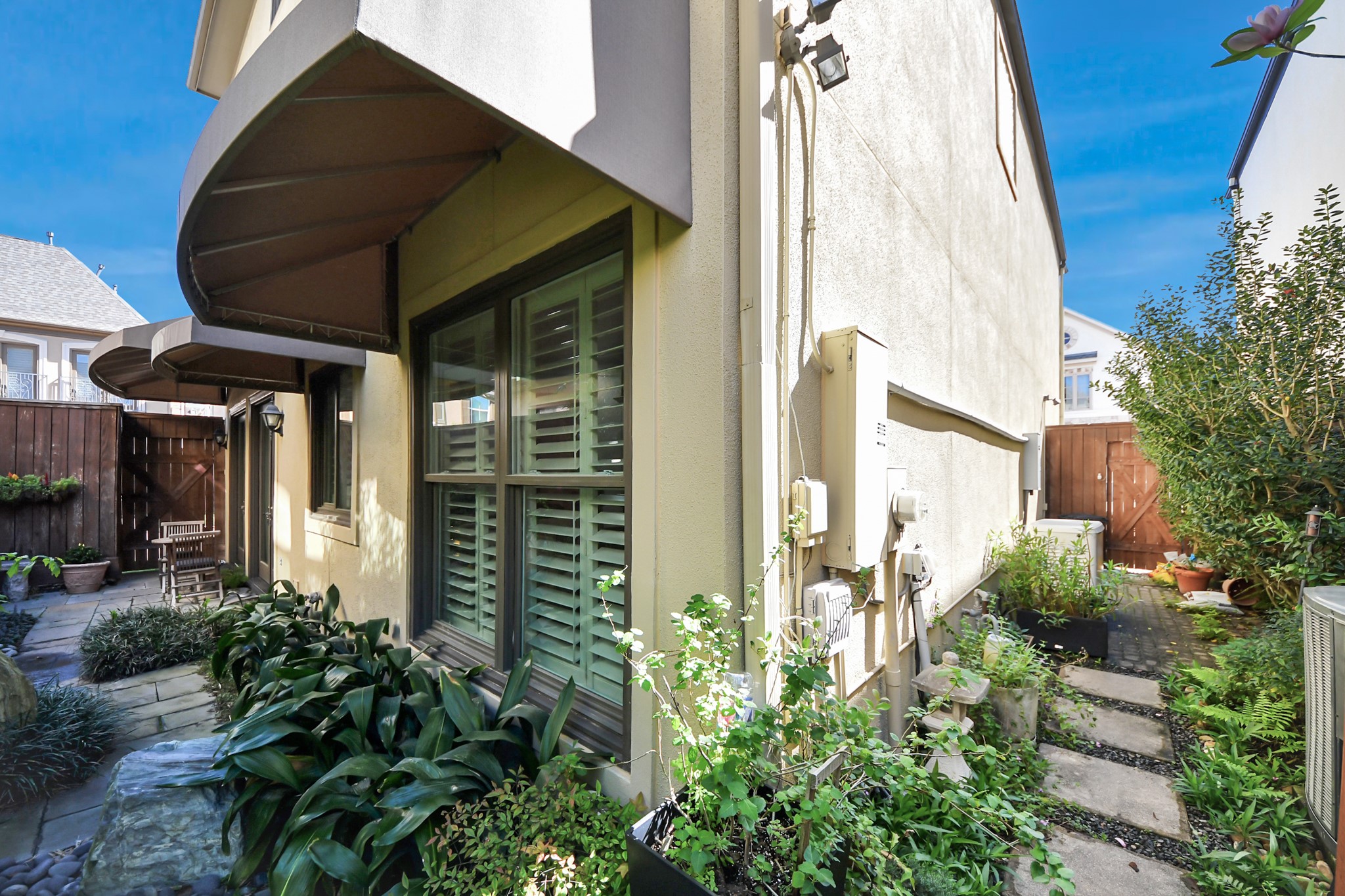 6302 Hermann Lake Drive Houston, TX 77021 - Photo 42 of 50 Step outside to a charming side courtyard where lush greenery and stone pathways create a peaceful outdoor retreat.
