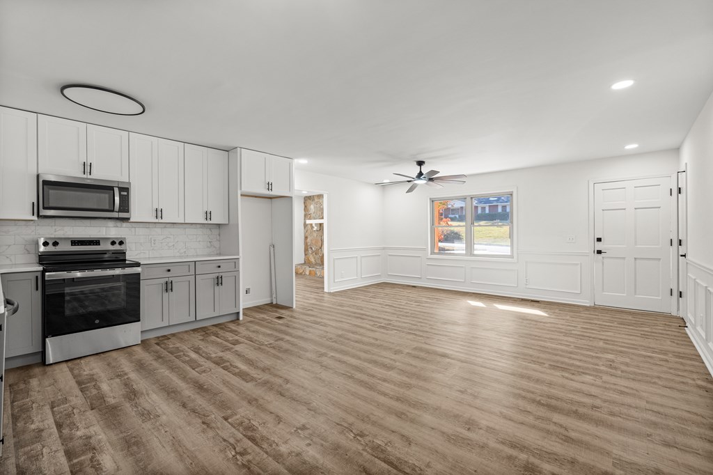 4903 Chapman Street Columbus, GA 31907 - Photo 3 of 14 a kitchen with granite countertop a stove and a refrigerator