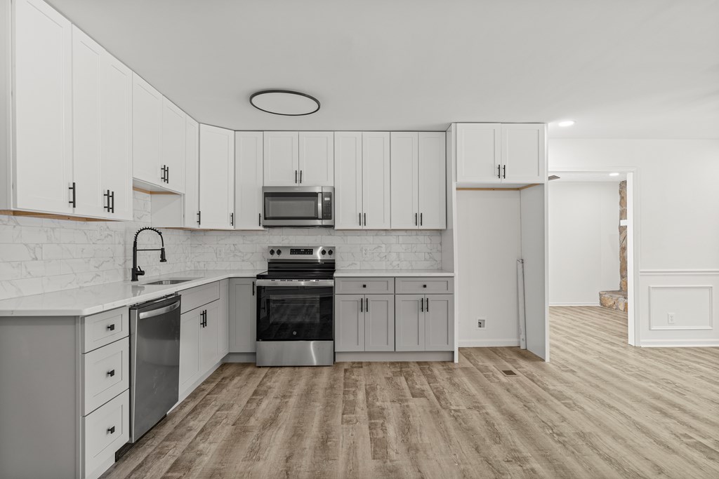4903 Chapman Street Columbus, GA 31907 - Photo 4 of 14 a kitchen with appliances cabinets and a sink