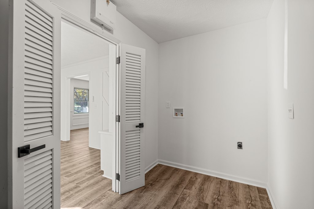 4903 Chapman Street Columbus, GA 31907 - Photo 7 of 14 a view of a hallway with wooden floor and closet