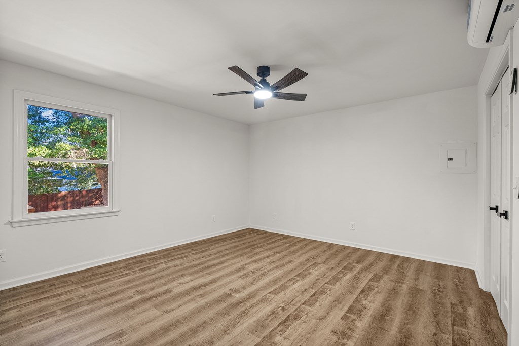 4903 Chapman Street Columbus, GA 31907 - Photo 9 of 14 an empty room with a window and a ceiling fan