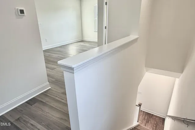 a view of bedroom with wooden floor