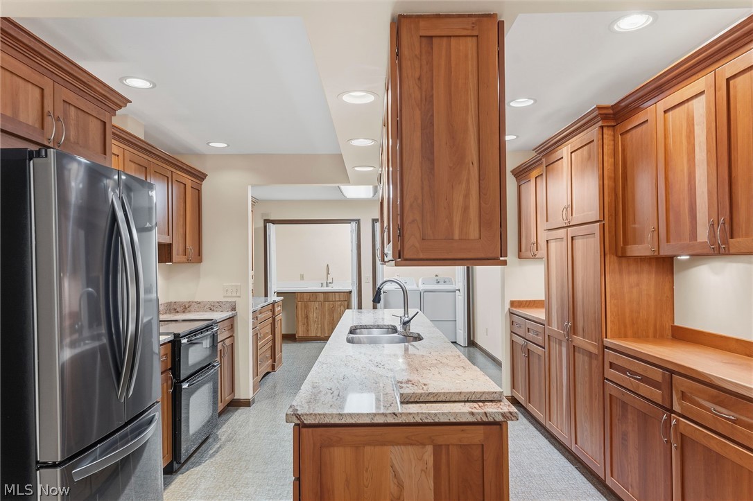 5741 Som Center Road, Unit 1 Solon, OH 44139 - Photo 17 of 50 Kitchen featuring extensive wood cabinetry, granite countertops, a stainless steel double-door refrigerator, a double wall oven, and recessed lighting