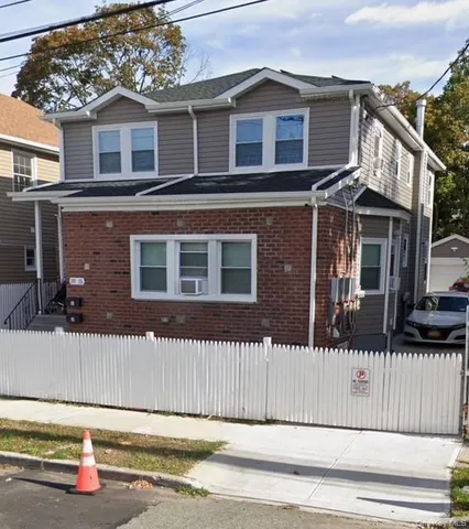 a front view of a house with a fence