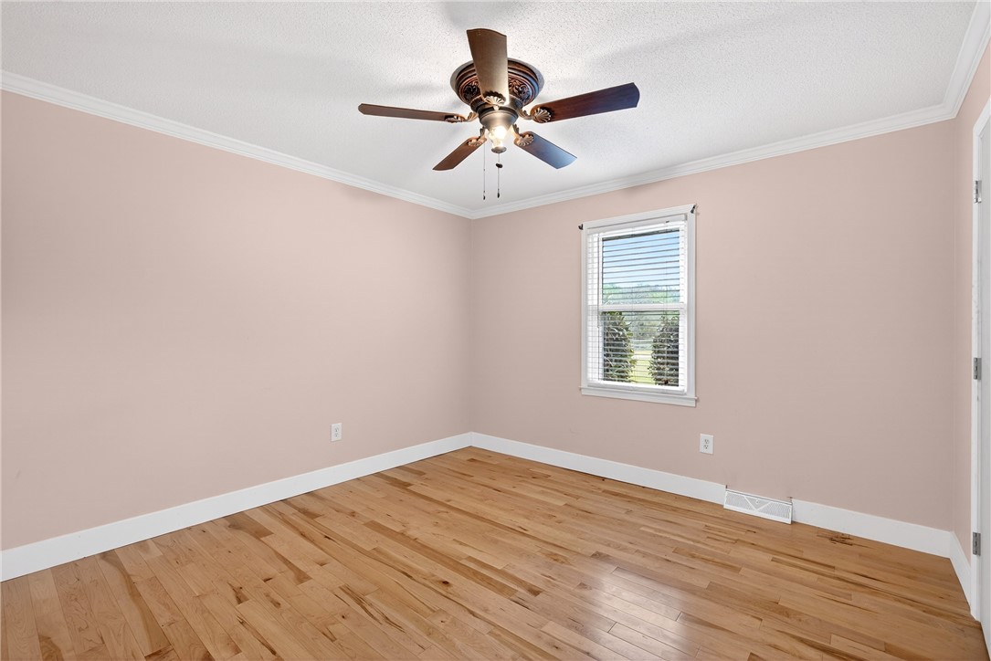 160 Burdette Circle Pendleton, SC 29670 - Photo 26 of 38 This inviting bedroom features rich hardwood flooring and a stylish ceiling fan.