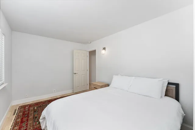 a bedroom with a bed and a night stand