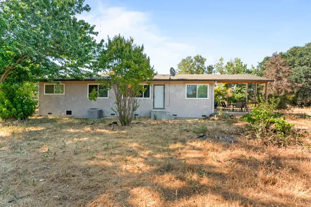 a view of a house with yard and a tree