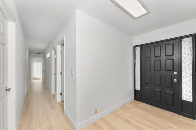 a view of hallway with wooden floor