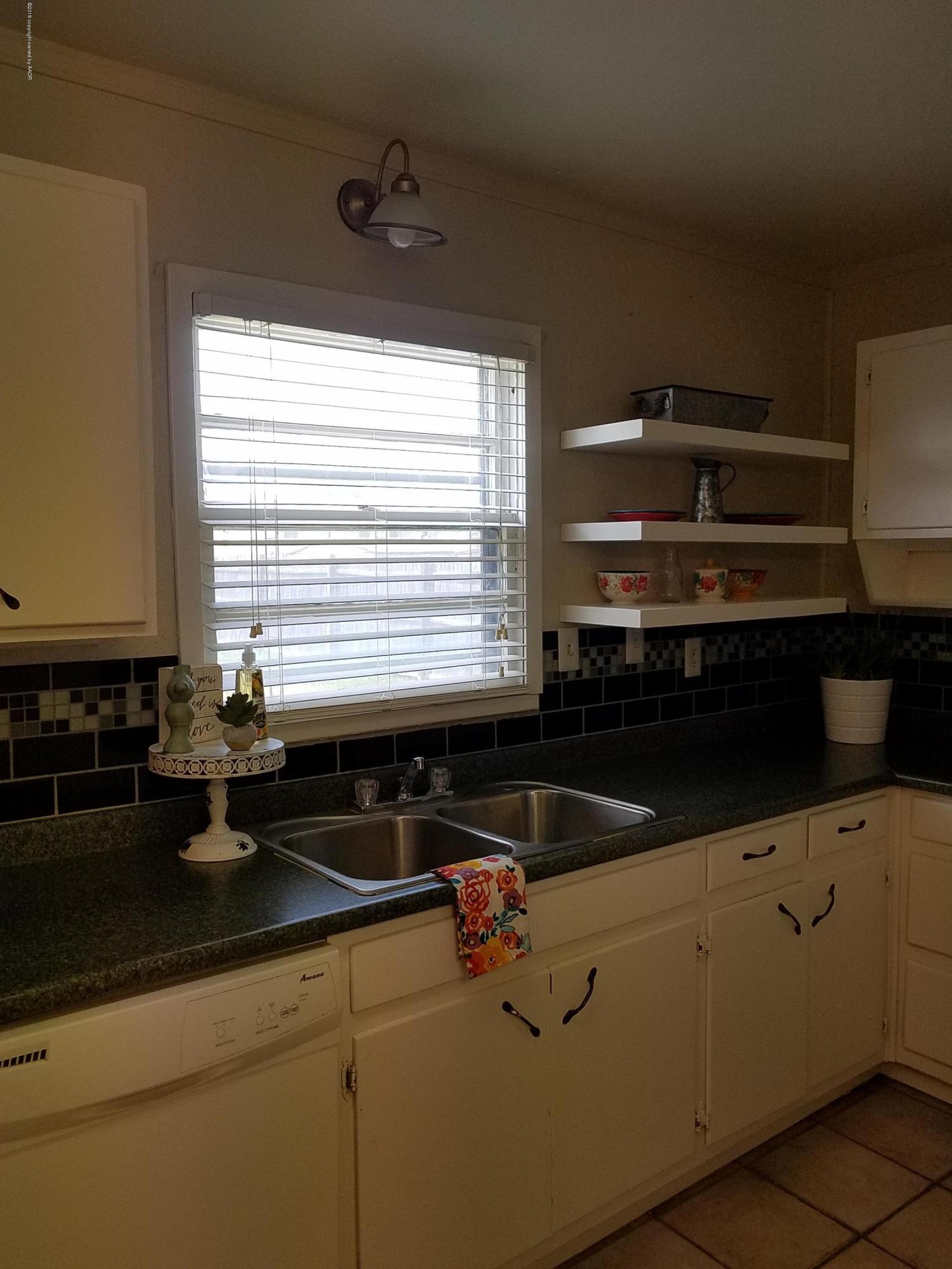 5004 Bowie Street Amarillo, TX 79110 - Photo 3 of 18 a kitchen with a sink and cabinets