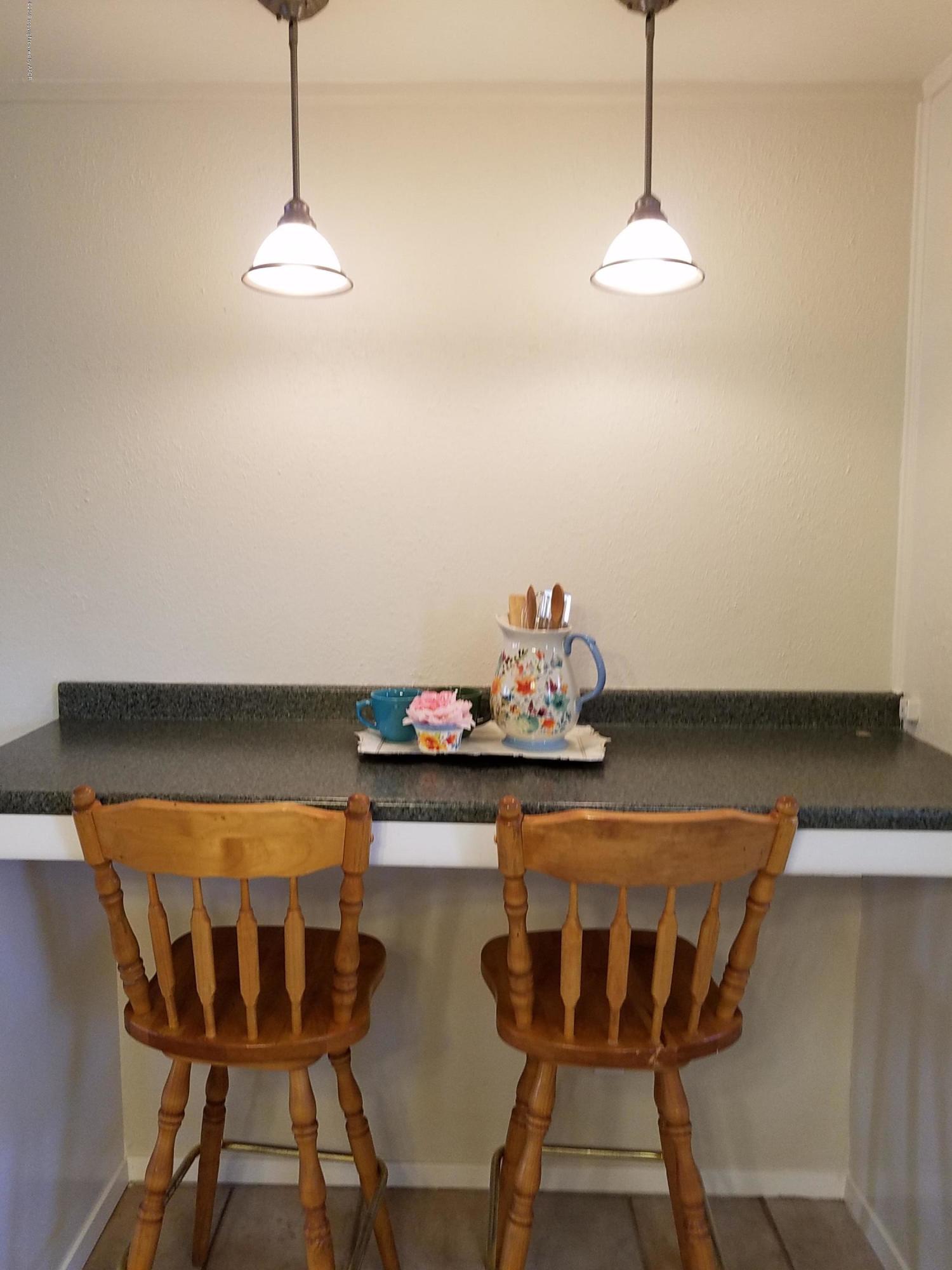 5004 Bowie Street Amarillo, TX 79110 - Photo 8 of 18 a view of a dining room with furniture and chandelier