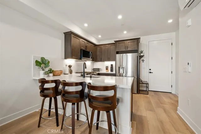 a kitchen with stainless steel appliances a sink stove and cabinets