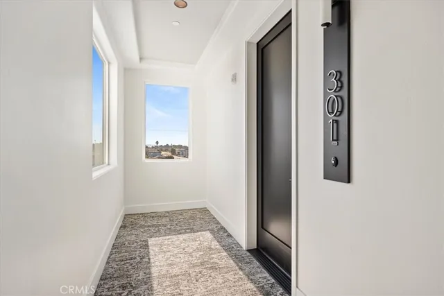 a living room with furniture a flat screen tv and a window