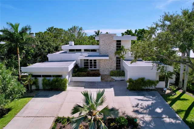 an aerial view of a house with garden space and a patio