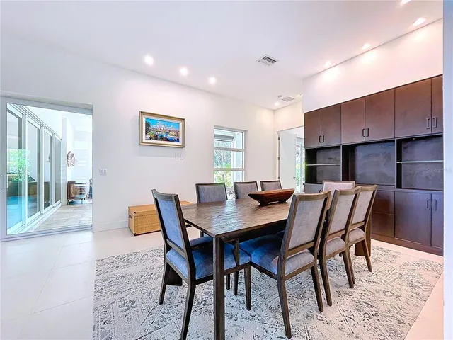 a spacious bathroom with a granite countertop double vanity sink a mirror and a bathtub