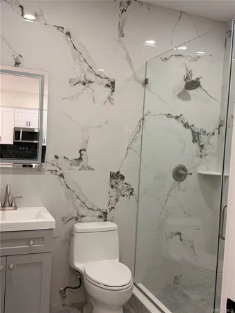 a bathroom with a sink toilet and shower